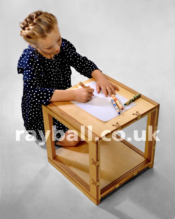 Little girl from Stoneleigh at flat pack desk designed in Horsham at Epsom Photography Studio Surrey.